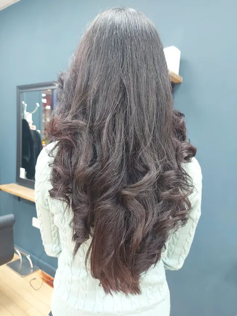 Long brunette bouncy curls styled for an event